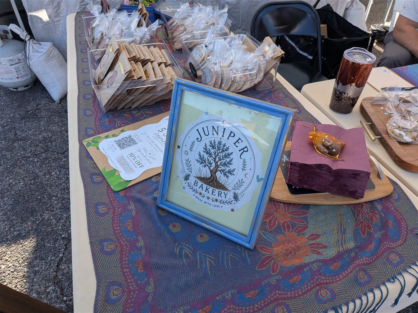 Juniper Bakery market table with framed logo