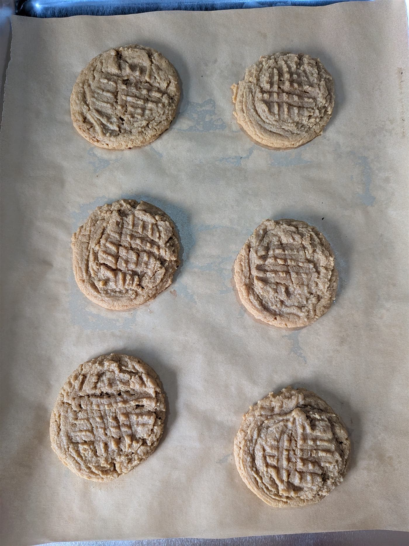 Peanut butter cookies cooling on parchment